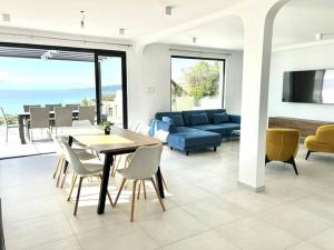 a living room with a couch and a table and chairs at Villa Balchik in Balchik