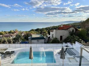 a swimming pool with a view of the ocean at Villa Balchik in Balchik
