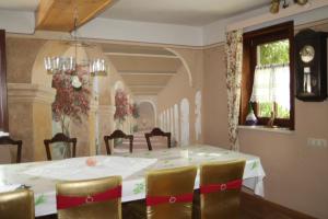 a dining room with a white table and chairs at Pension Rhöner Kräuterwerk 