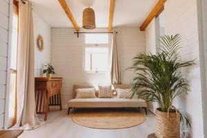 a living room with a couch and a window at Dreamsea Bungalows Alentejo in Porto Covo