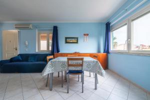 a living room with a table and a couch at Casa Murru in SantʼAntìoco