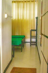 a room with a green table and a chair at Hotel Sanasuma in Hambantota