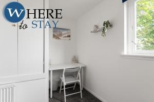 a home office with a desk and the words where to stay at Lovely 2 bedroom house Edinburgh in Edinburgh