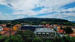 a view of a town with a mountain in the background at Penthouse Mały Belweder in Ustrzyki Dolne +1 photo