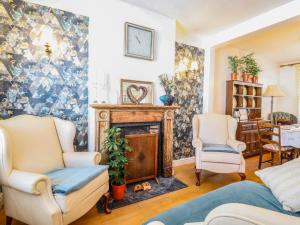 a living room with two chairs and a fireplace at Hertford Street in Cambridge