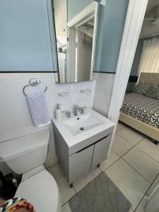 a bathroom with a sink and a toilet and a mirror at Suite Love in Miami Beach