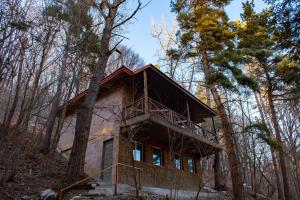 a house in the middle of the forest at Maestro Rest House Dilijan in Dilijan