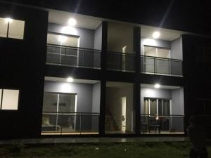 a night view of a building with lights at Departamento Confortable in Puerto Iguazú