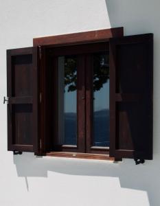 a window on the side of a building at Athos Cape in Pyrgadikia