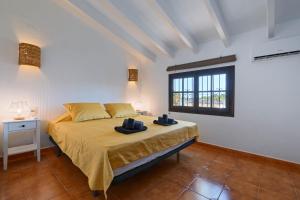 a bedroom with a bed and a window at Casa Kirsten in Moraira +16 photos
