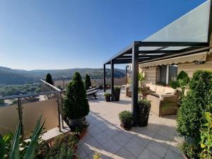 a patio with a table and chairs on a house at The View Veliko Tarnovo in Veliko Tŭrnovo