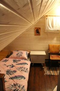 a bedroom with a bed and a desk in a room at Niezapominajka in Bystrzyca Kłodzka