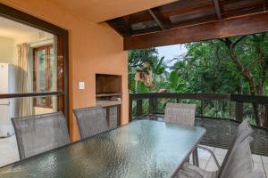 a dining room with a table and chairs on a balcony at San Lameer Villa 3014 - 3 Bedroom Classic - 6 pax - San Lameer Rental Agency in Southbroom