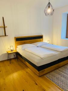 a bedroom with a large bed with a wooden headboard at Schurianhof in Timenitz