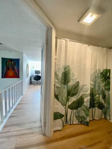 a hallway with a curtain with a plant on it at Logement au Cœur du Village in Saint-Jean-Port-Joli