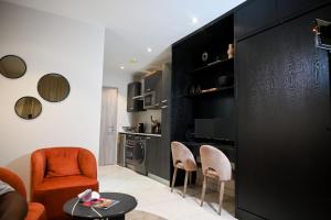 a living room with two chairs and a table at The Broadway @The Lennox in Accra