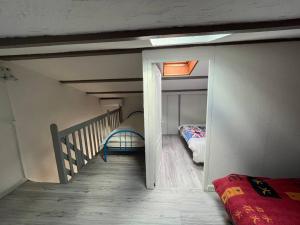 a room with a staircase and a room with two beds at Charmant pavillon pour 5-6 pers. in Cap d'Agde