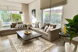 a living room with a couch and a coffee table at Sindbad House in La Marsa