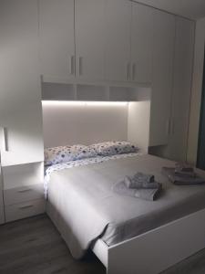a bedroom with a white bed with towels on it at Dream Baveno 2 in Baveno