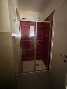 a shower with a glass door in a bathroom at Dream Baveno 2 in Baveno