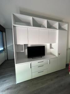 a large white entertainment center with a tv on it at Dream Baveno 2 in Baveno