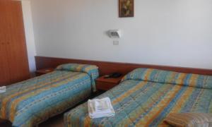 A bed or beds in a room at Osteria dei Locandieri
