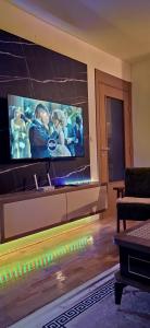 a living room with a large flat screen tv at Chill out apaRtMent in Foča