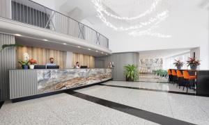 a rendering of a lobby with a reception desk at IH Hotels Milano Centrale in Milan