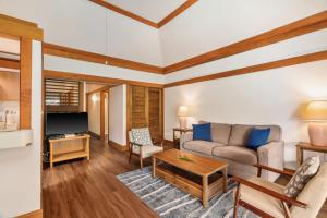 a living room with a couch and a tv at Charming 1br TopFloor Condo in Poipu, Athletic Club 432 in Koloa