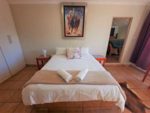 a bedroom with a bed with two pillows on it at Highlands Creek Self Catering Accommodation in Nelspruit