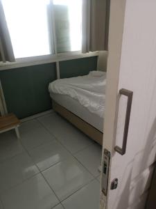 a small room with a bed and a window at COZY HOUSE Working Space Stay with local in Bangkok Airport in Bangna