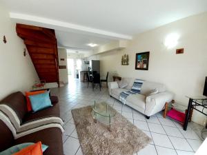 a living room with a couch and a table at 57 Settler Sands Beach Apartment in Port Alfred