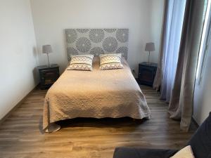 a bedroom with a large bed with two night stands at Le defi in Fouras