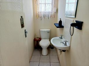 a bathroom with a toilet and a sink at 57 Settler Sands Beach Apartment in Port Alfred
