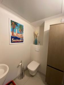 een badkamer met een wit toilet en een wastafel bij Spacieux appartement avec jardin dans résidence de grand standing avec piscine in Sanary-sur-Mer