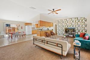 a living room with a couch and a kitchen at Cassia Tree in Twentynine Palms