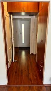 um corredor vazio com uma porta e pisos de madeira em Casa Maria em Budapeste