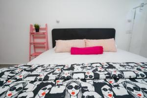a bed with a black and white blanket with cows at חצבים על הואדי in Arad