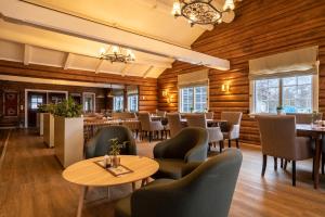 restauracja z drewnianymi ścianami, stołami i krzesłami w obiekcie Vollan Gjestestue w mieście Nordkjosbotn