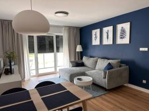 a living room with a couch and a table at Baltic Nest - Dziwnów in Dziwnów