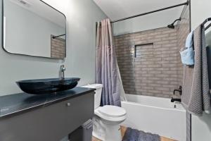 a bathroom with a sink and a toilet and a mirror at Gainesville-newly remodeled home in Gainesville