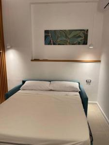 een bed in een kamer met een schilderij aan de muur bij Oleander Apartment in Castellammare di Stabia