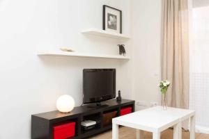 a living room with a tv and a table at Port VI Apart céntrico ideal familias 22 in Barcelona