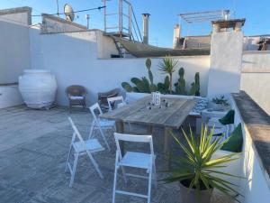 a patio with a wooden table and chairs at Casa Annina in Gallipoli