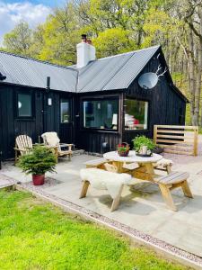 a patio with a picnic table and a house at Stag's Hide in Aviemore
