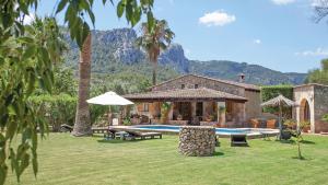 a house with a yard with a swimming pool at Villa Alyvos Pollensa - BY EMERALD STAY in Pollença