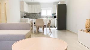 a living room with a couch and a table at Zoe in Nea Kallikrateia