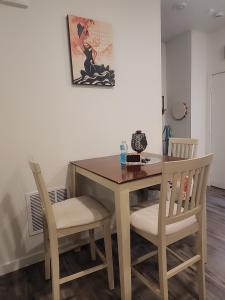 a dining room table with two chairs and a table at Cozy, Quiet Shared Room & Home in Watkins