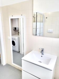 a bathroom with a sink and a washing machine at Rho Mind Fiera House in Rho