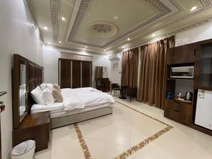a bedroom with a bed and a desk in a room at Friday Suites in AlUla +79 photos